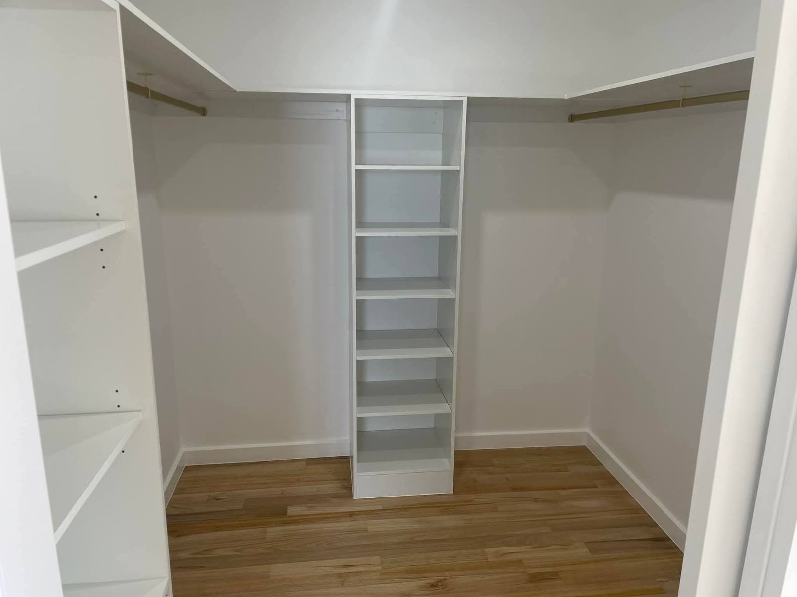 Walk-in wardrobe with custom shelving and hanging rails